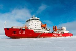 Research vessel "Chinare", red and white, ice, blue sky with clouds