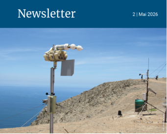 Scientific devices installed on a rocky cliff by the ocean, under a clear blue sky. Coastal landscape with scientific instruments.